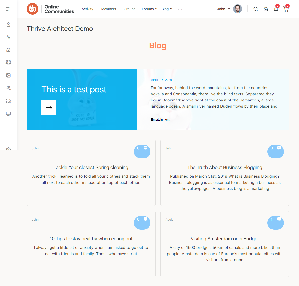 A blog page with a blue featured post titled This is a test post and four article cards below on business, healthy eating, cleaning tips, and Amsterdam travel. The site menu is on the left and the user profile is at the top right.