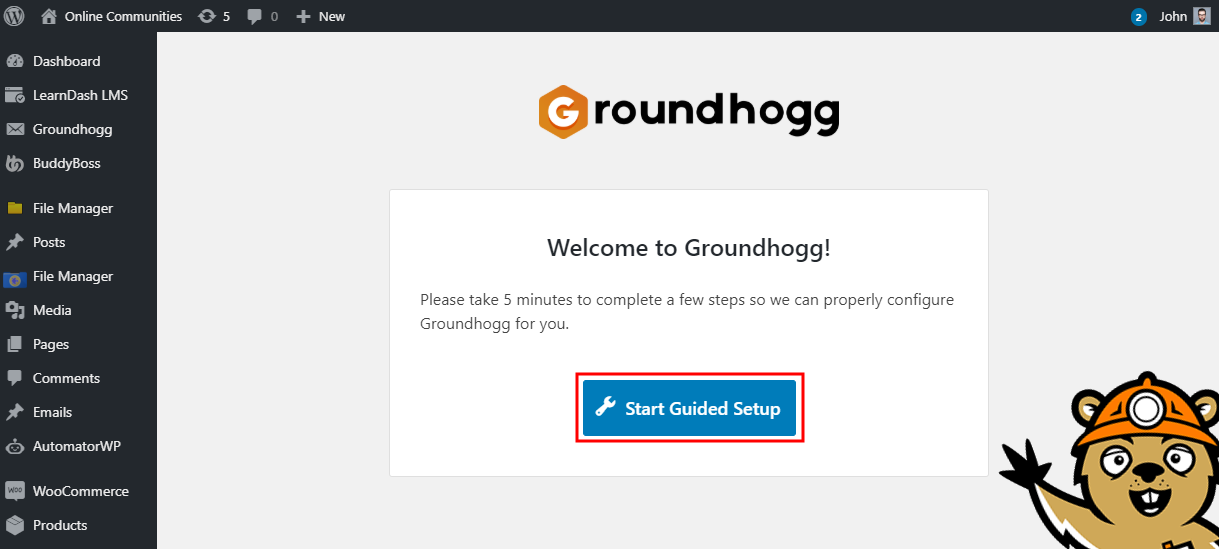 Screenshot of the Groundhogg plugin welcome screen in WordPress, prompting the user to click a blue Start Guided Setup button; a cartoon animal character is waving in the bottom right corner.